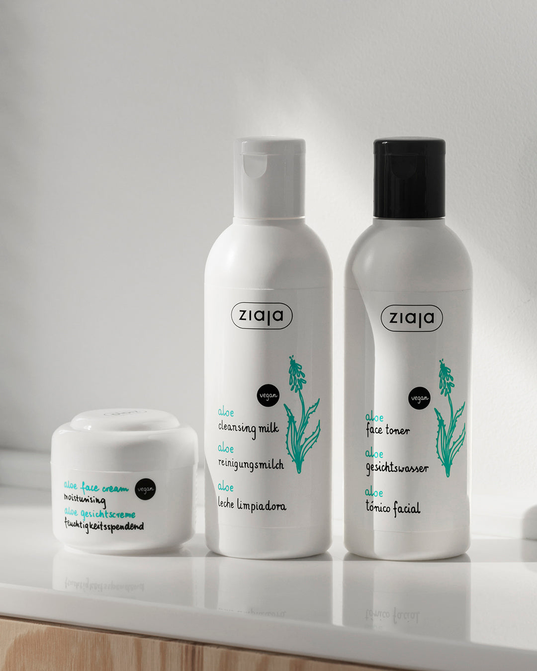 Three Ziaja skincare products on a light surface with a neutral background