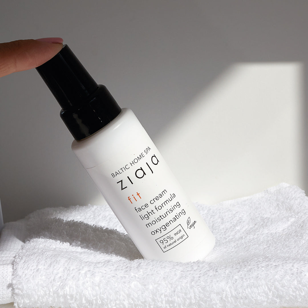 Face cream bottle on a white towel