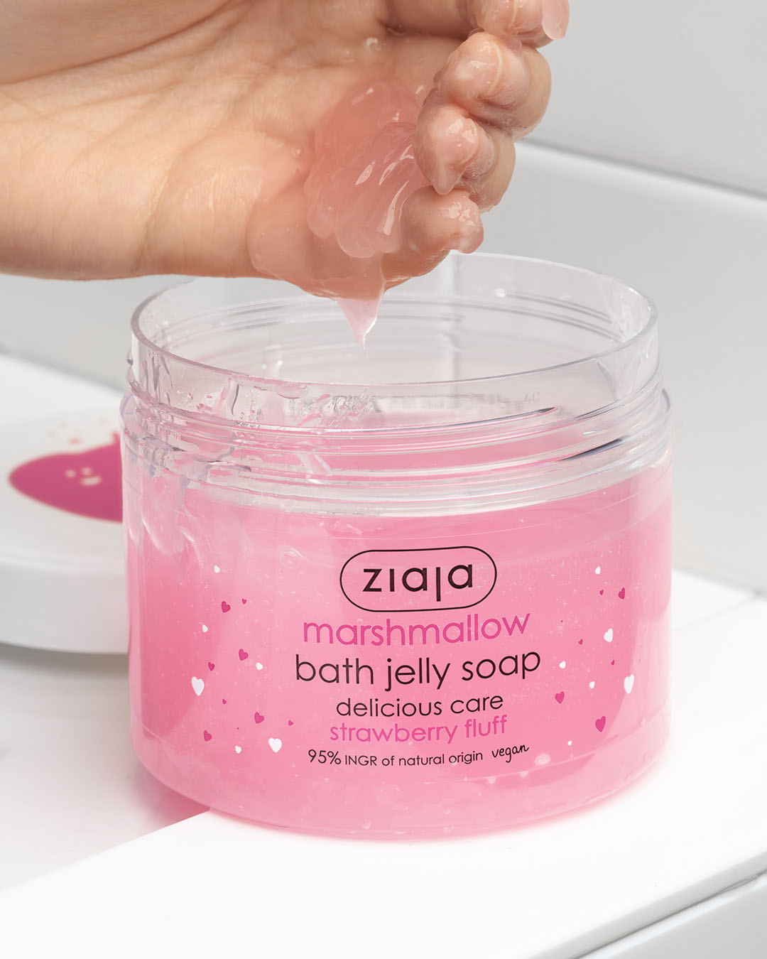 Pink Ziaja marshmallow bath jelly soap being squeezed out of a jar.