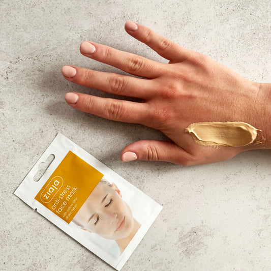 Ziaja anti-stress face mask sachet with clay texture applied on hand, smoothing skincare treatment for all skin types