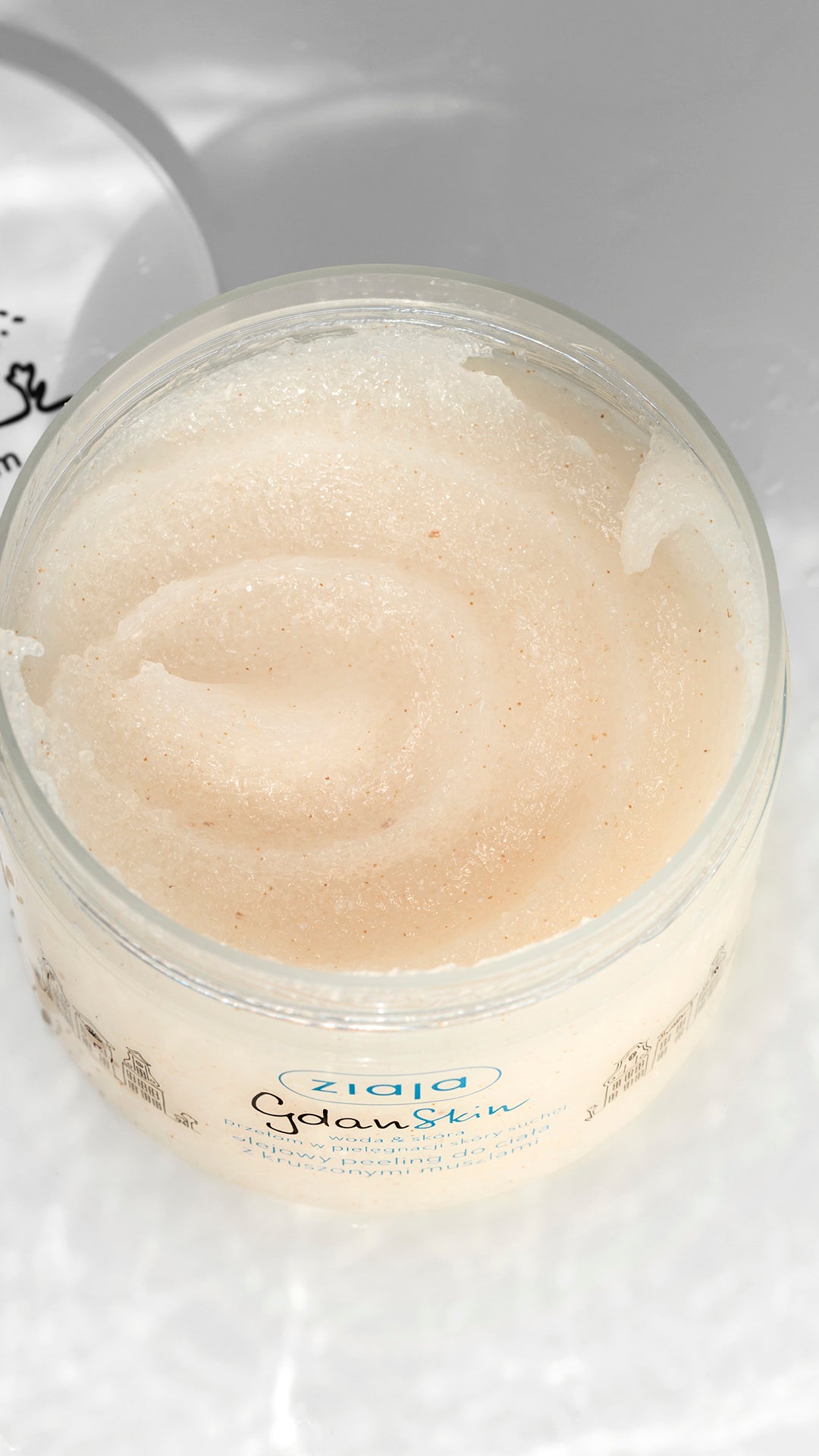 Jar of Ziaja body scrub on a white background