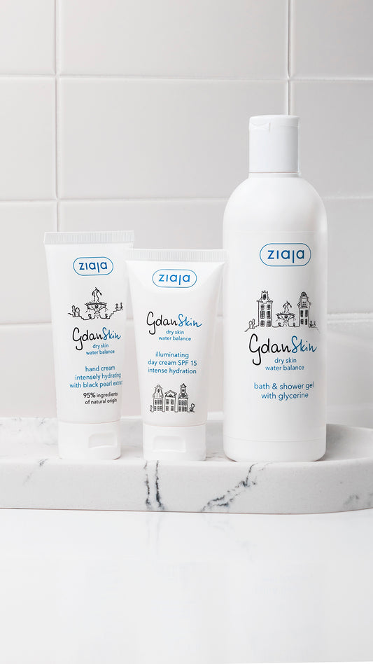 Ziaja skincare products on a marble surface with a tiled wall background