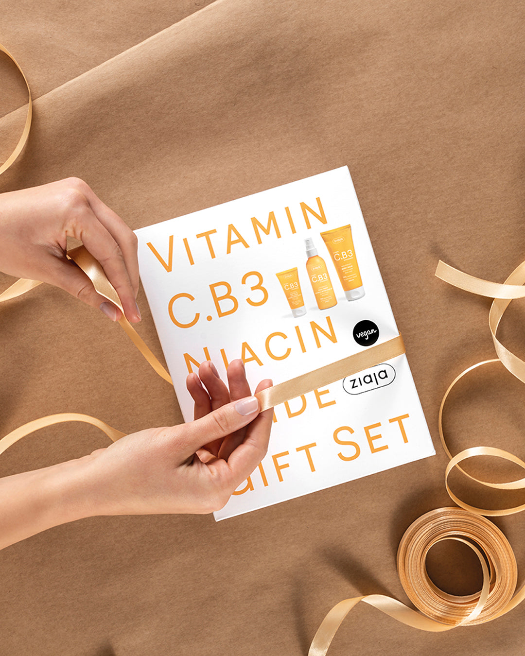Gift set packaging for Vitamin C, B3, and Niacin on brown paper background.