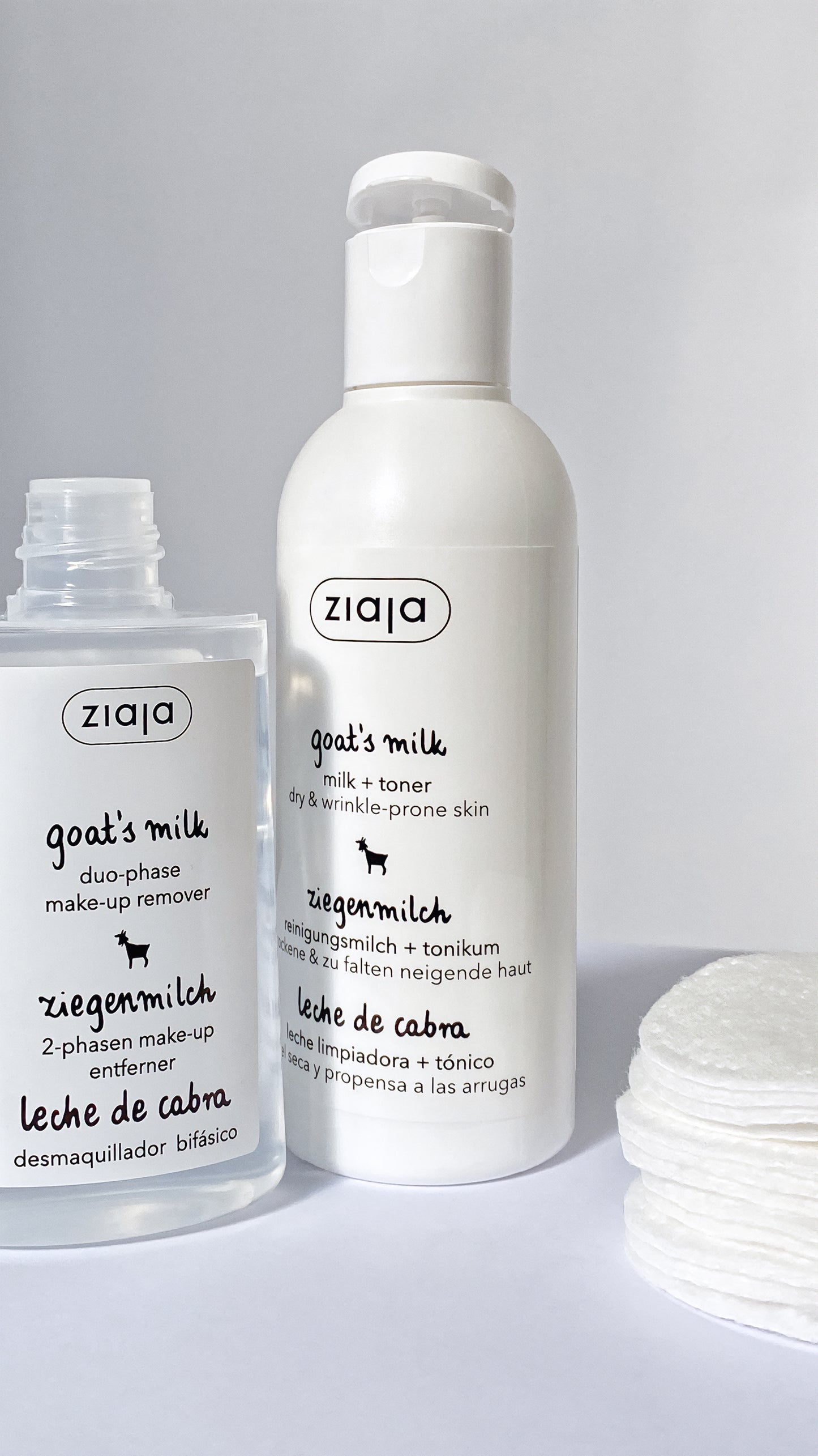 Two bottles of Ziaja goat's milk skincare products on a white background