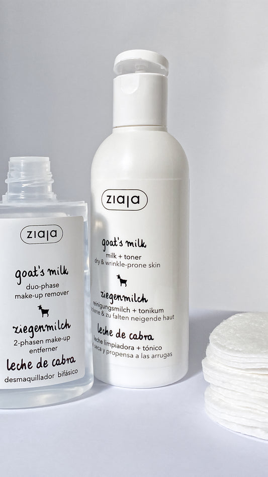 Two bottles of Ziaja goat's milk skincare products on a white background