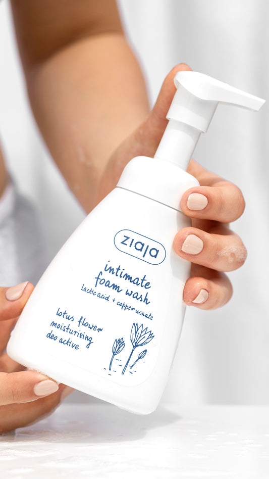 Ziaja intimate foam wash bottle held by a person with a white background