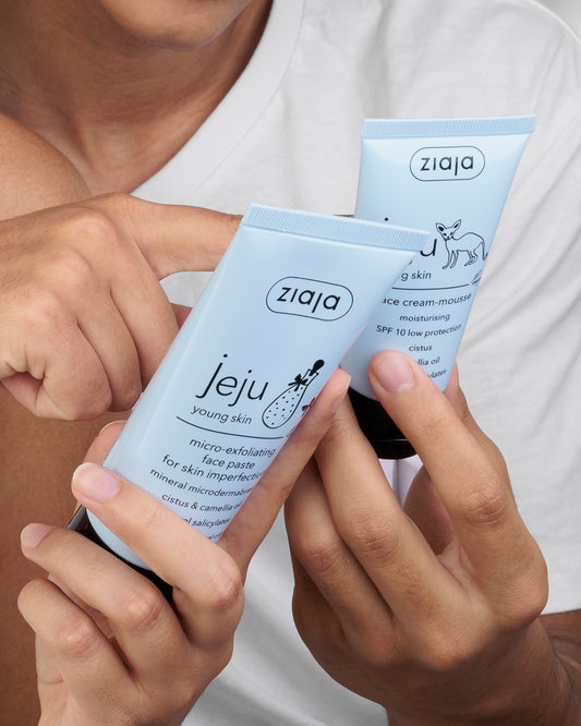Two Ziaja skincare products held by a person against a white background