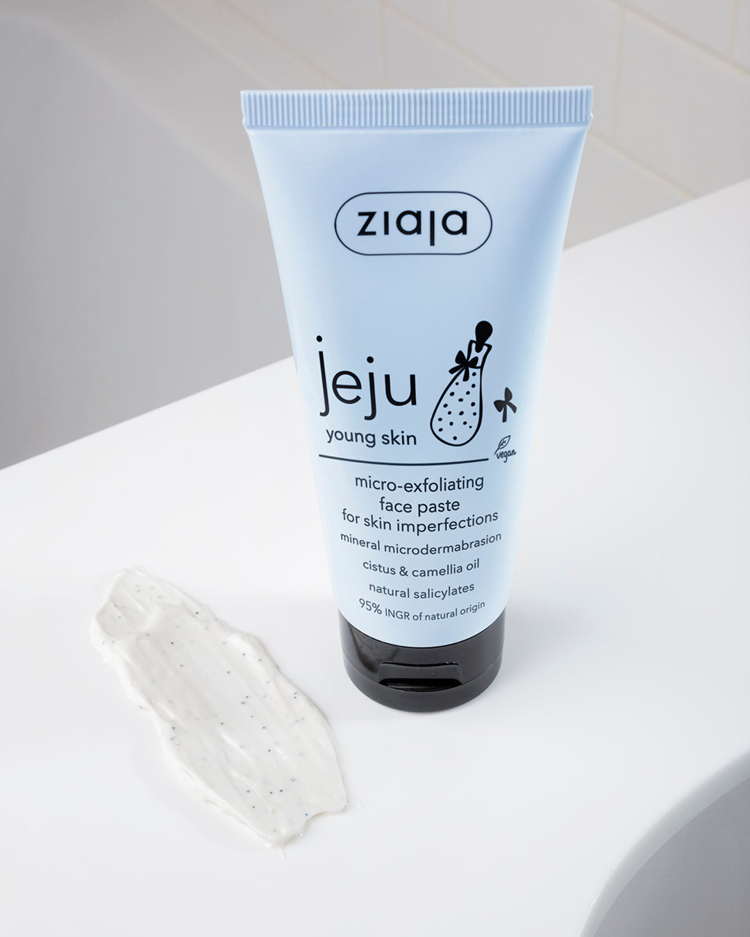 Ziaja Jeju micro-exfoliating face paste tube on a white surface with a gray background