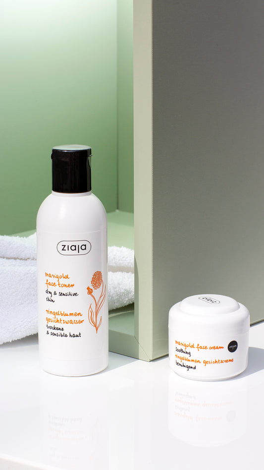 Two white skincare products from the brand Ziaja, including a facial toner bottle and a cream jar, styled on a white surface with a green background.