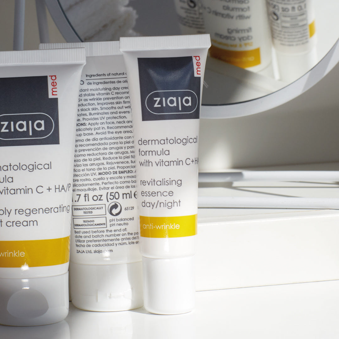 Ziaja Med Revitalising Essence Day/Night (vitamin C + HA) tube on a bathroom counter, with product reflection in a mirror.