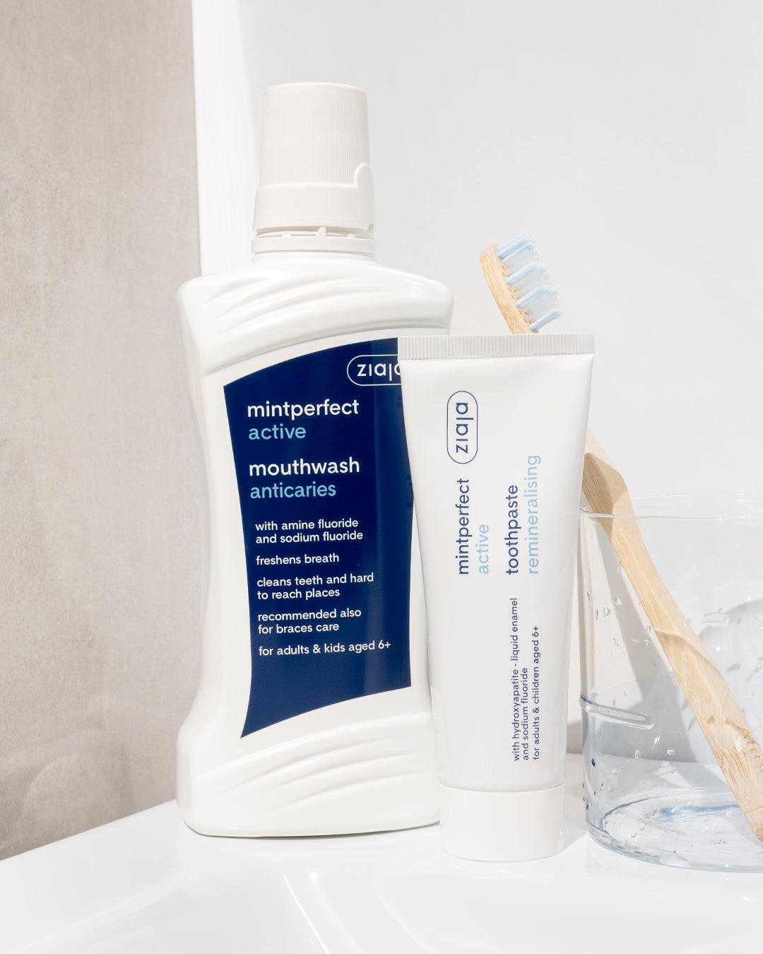 Ziaja Mintperfect mouthwash and toothpaste on a white surface with a neutral background