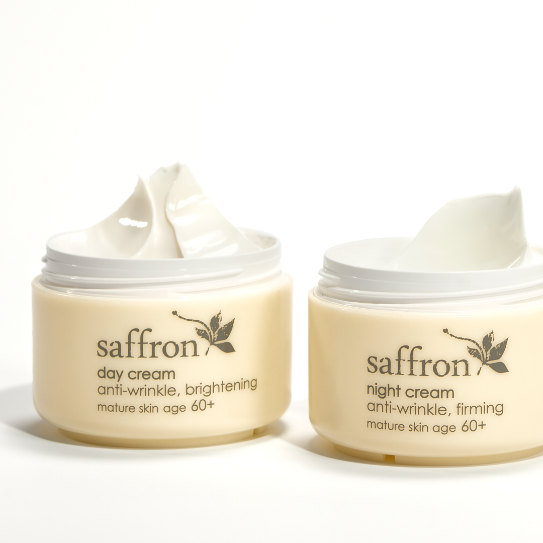 Two jars of Ziaja affron day and night cream on a white background