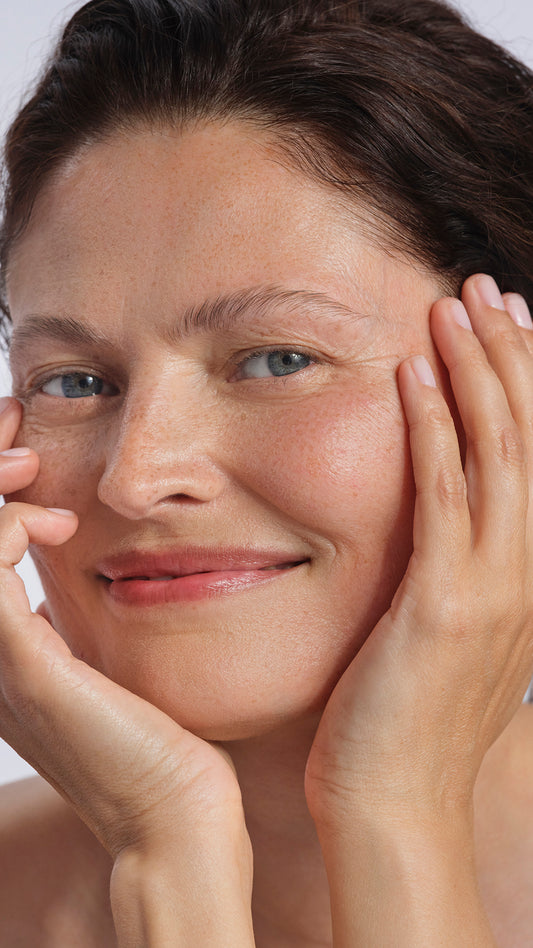 Woman with hands on face, close-up of skin texture