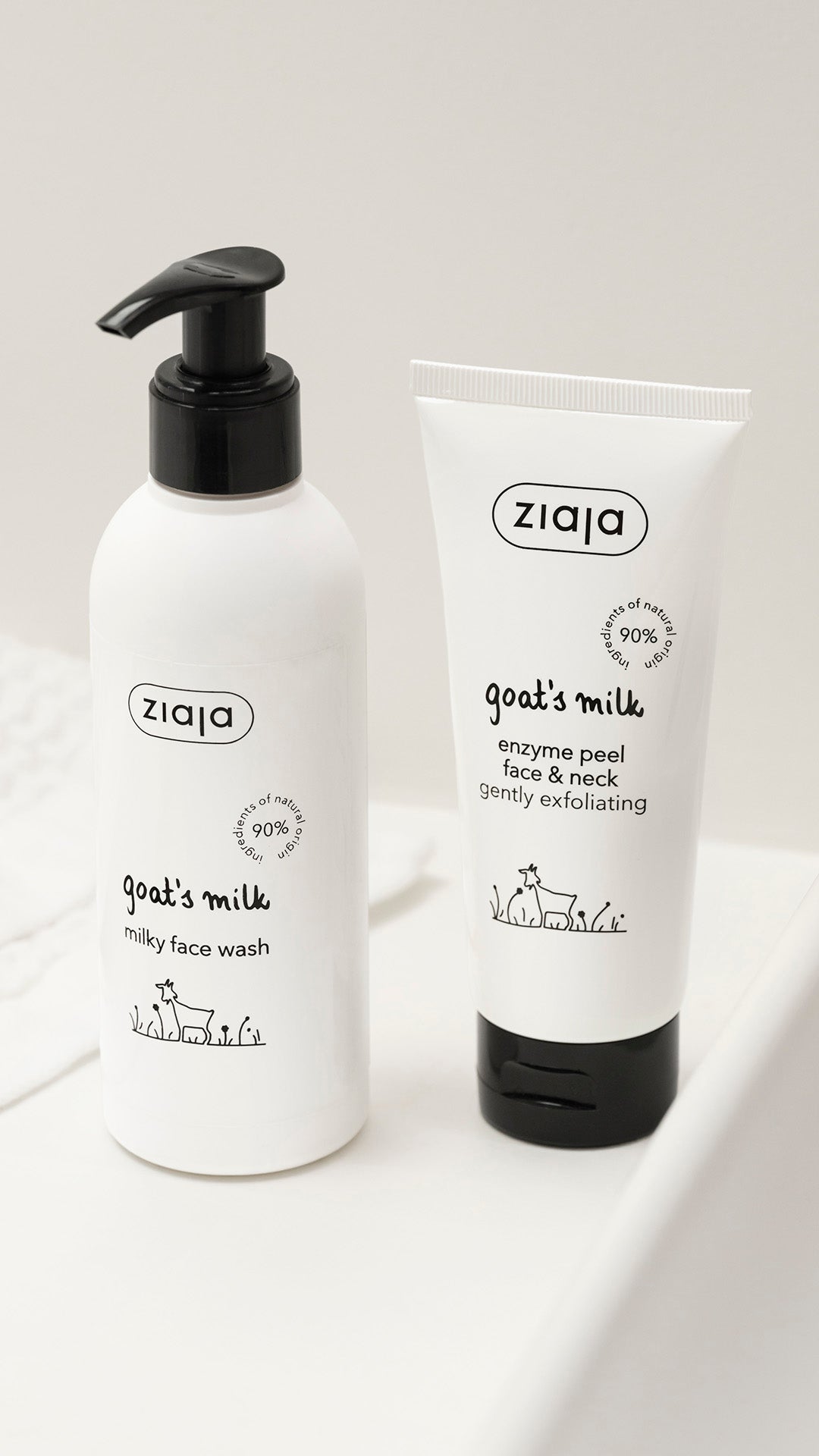 A white bottle of Ziaja Goat;s Milk Milky was and a white tube of Ziaja Goat's Milk enzyme peel against a white background. 