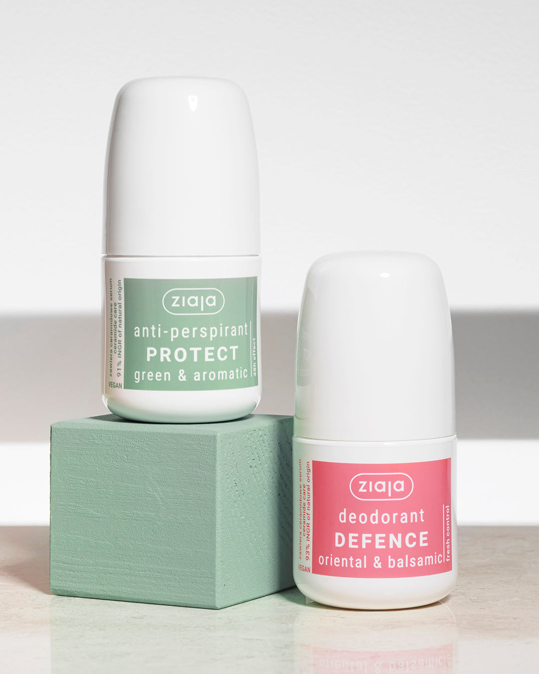 Two Ziaja deodorant bottles on a light background