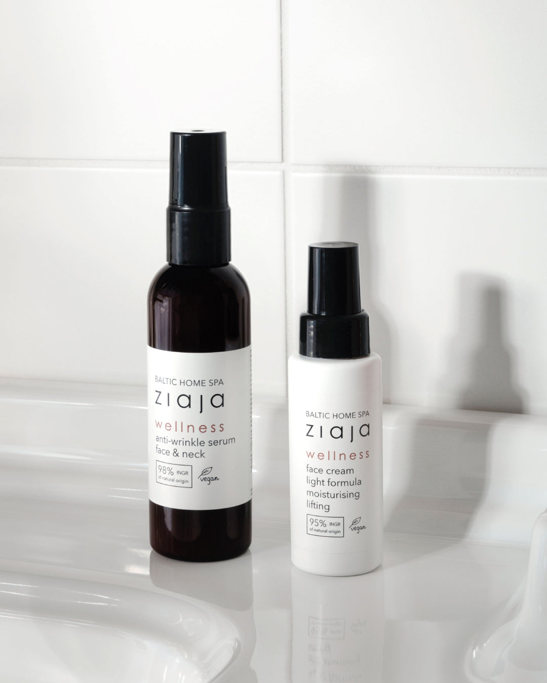 White bottle labeled Ziaja Baltic Home Spa Wellness face cream light formula with black pump dispenser standing on a white surface