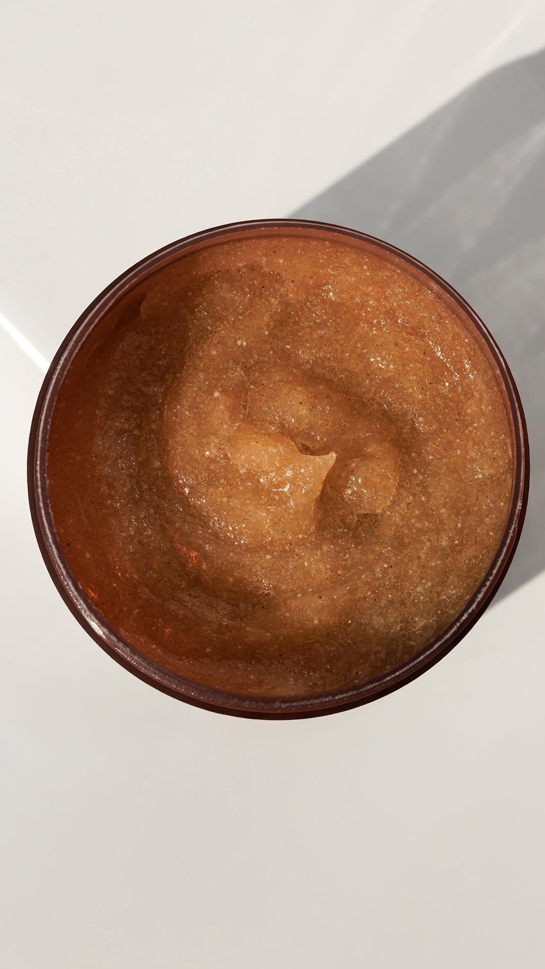 Ziaja Cocoa Butter shower scrub texture top view of exfoliating body scrub in jar