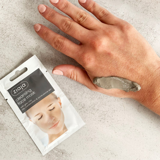 Ziaja cleansing face mask packaging with a hand applying the mask on a neutral background
