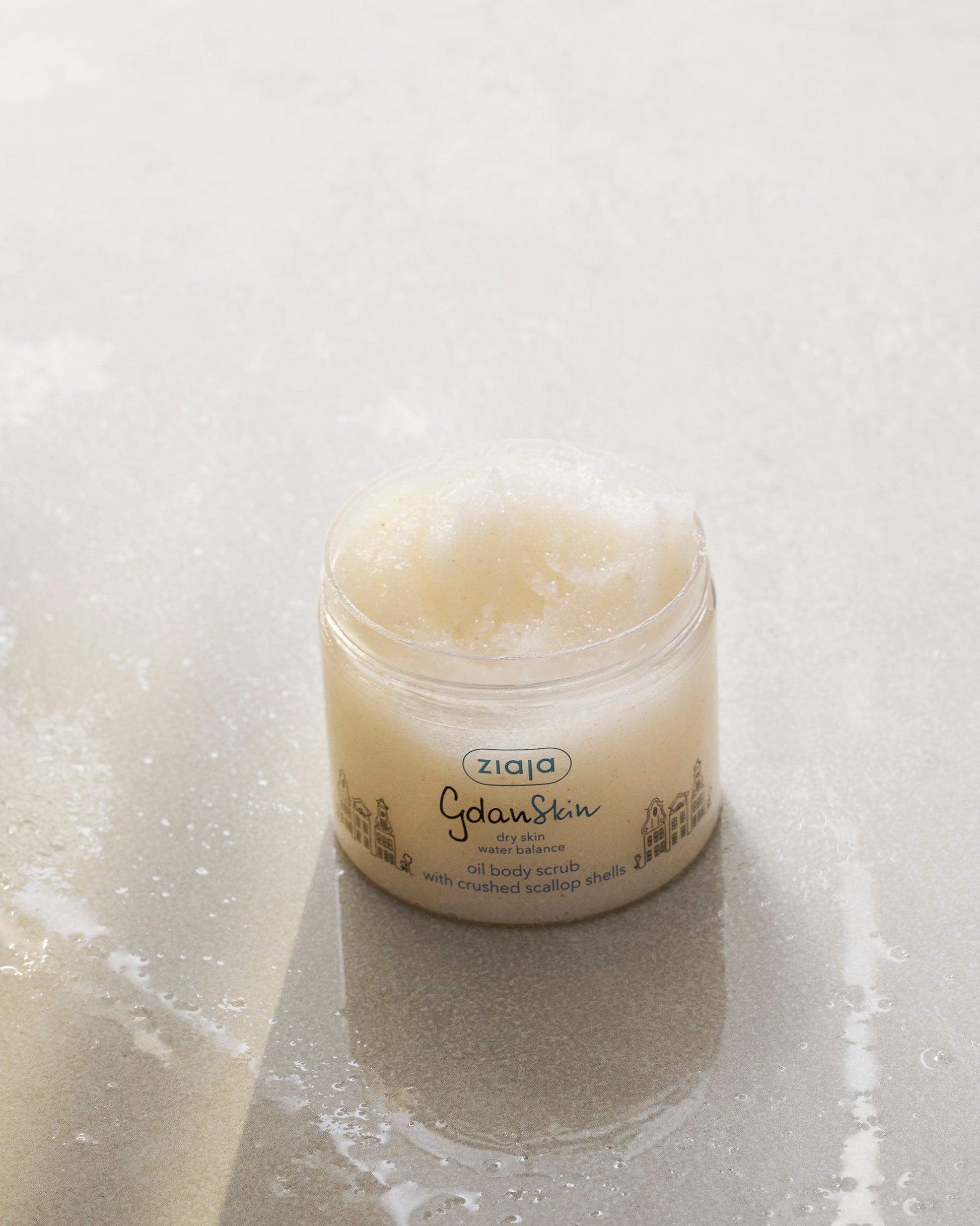Jar of Ziaja body scrub on a textured surface