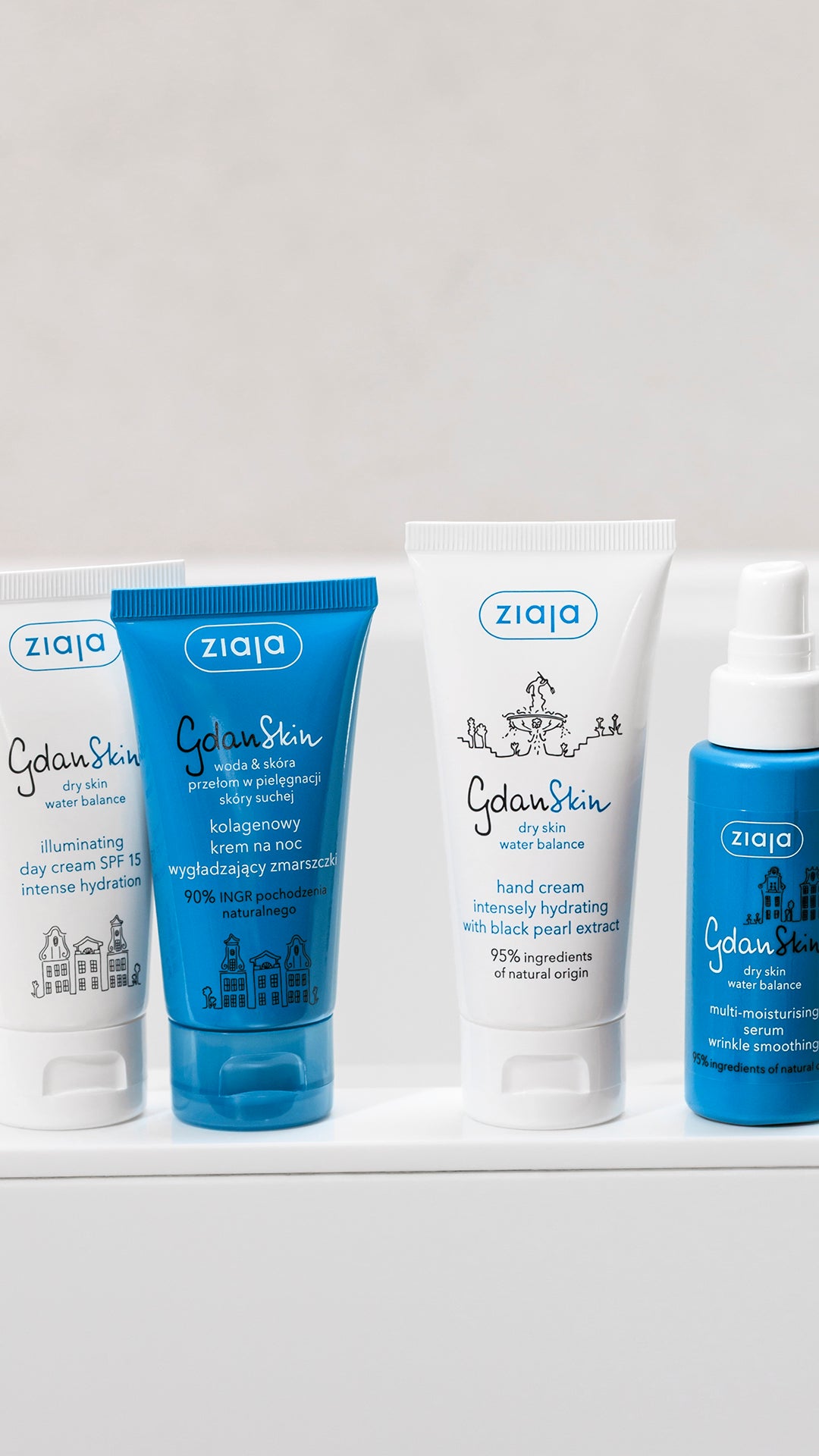 Ziaja skincare products including a bottle, tube, and cream on a white surface with a light gray background.