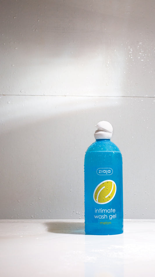 Blue bottle of Ziaja intimate wash gel on a white background