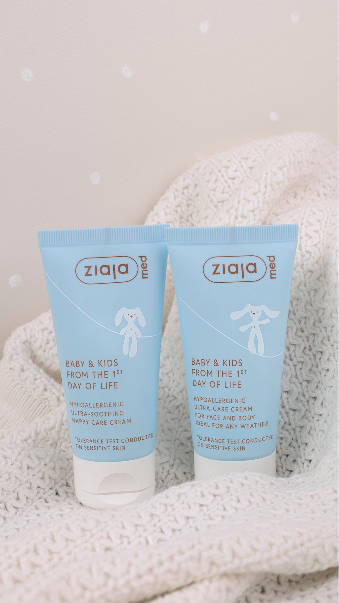 Ziaja Med Baby & Kids Ultra-Soothing Nappy Care Cream 50 ml tube shown next to Ziaja Med Baby & Kids Ultra-Care Cream, on a soft knitted blanket background.