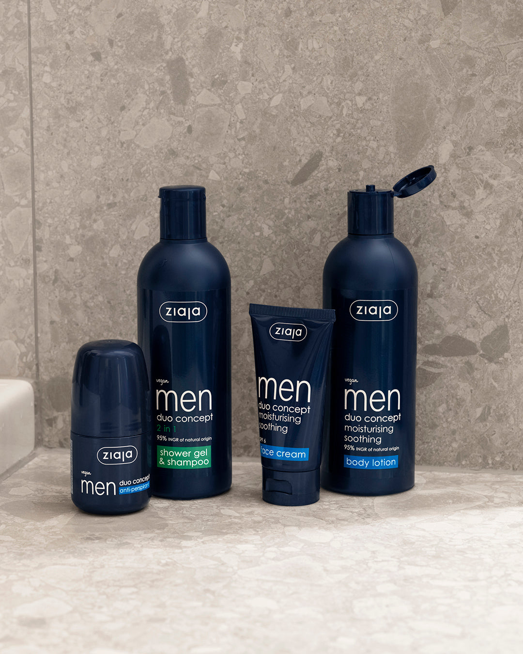 Ziaja Men Duo Concept range displayed on a bathroom surface: anti-perspirant, 2-in-1 shower gel & shampoo, face cream, and body lotion.