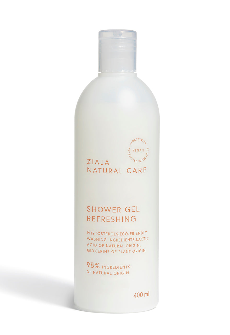 A white bottle of Ziaja Natural Care Shower Gel with brown text, indicating the product is vegan and refreshing.