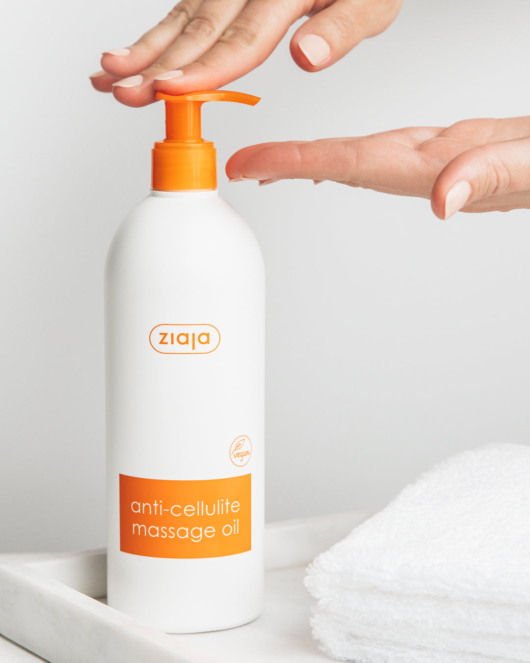 Ziaja anti-cellulite massage oil bottle with pump on a light background