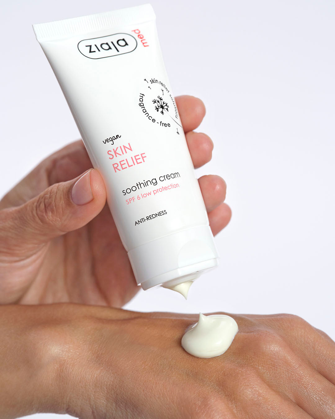 Ziaja Skin Relief sampled on a palm of a hand, the other hand is holding the tube of Ziaja cream. 