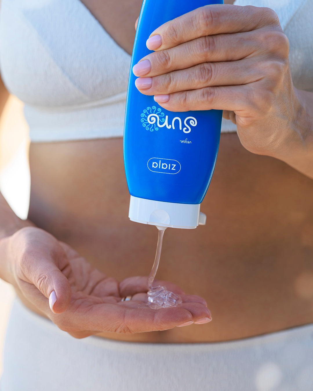 Pouring Ziaja Sun After Sun Soothing Gel into hand, close-up application shot