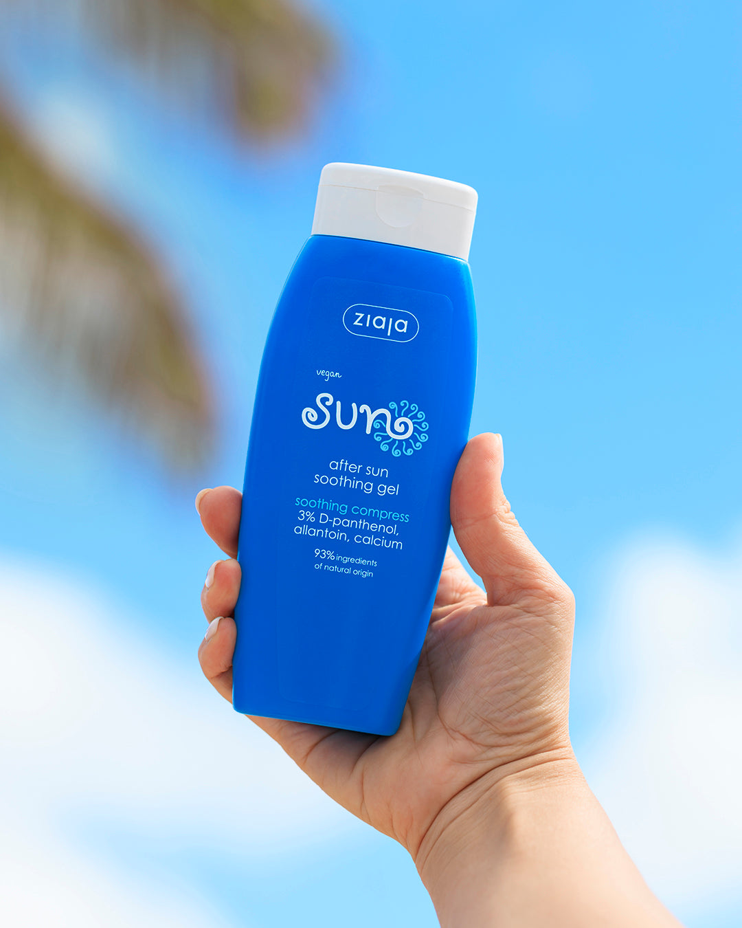 Ziaja Sun After Sun Soothing Gel bottle held up against a blue sky, close-up