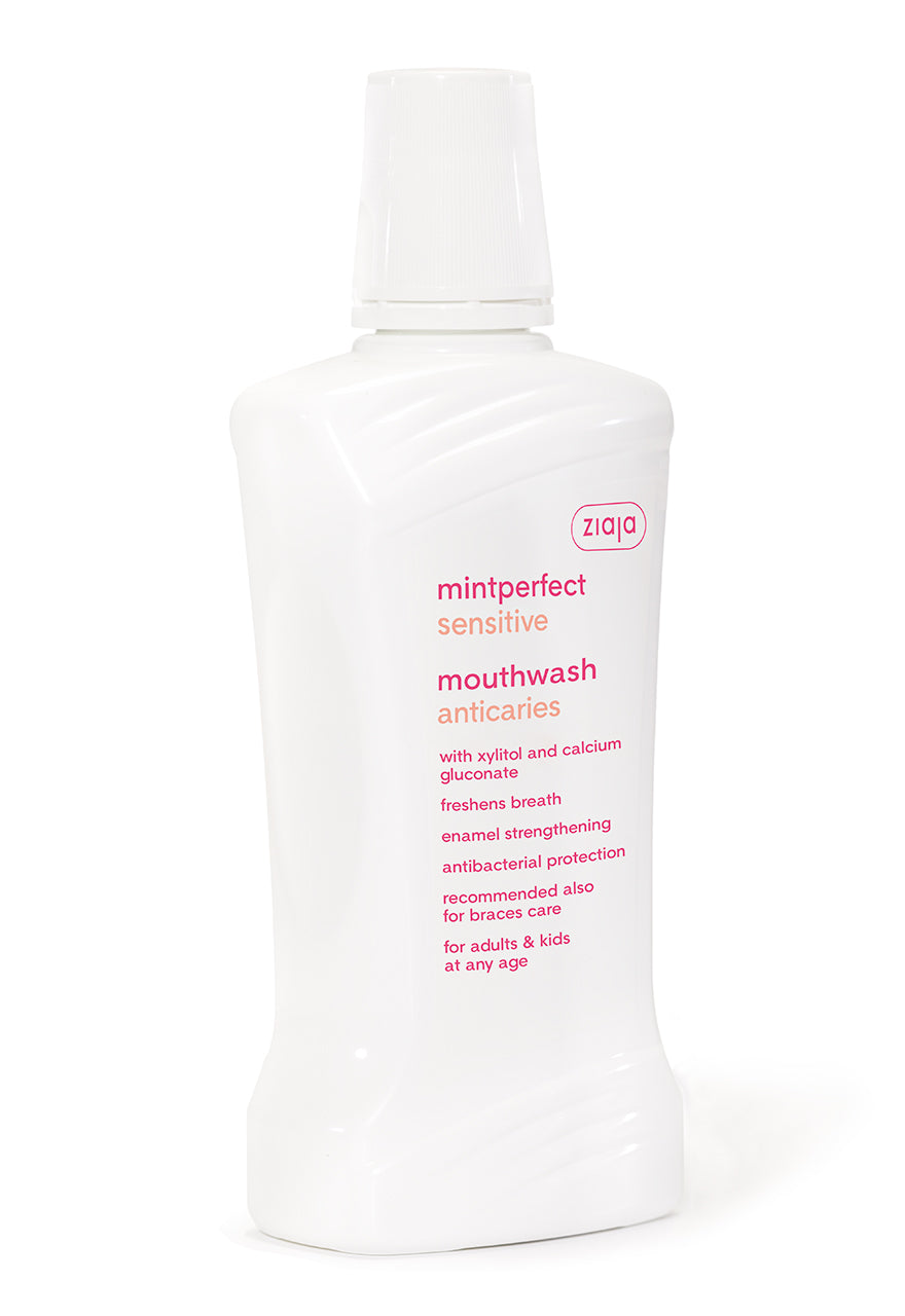 A bottle of Ziaja Mintperfect Sensitive Anticaries Mouthwash 500ml with pink text and design elements.