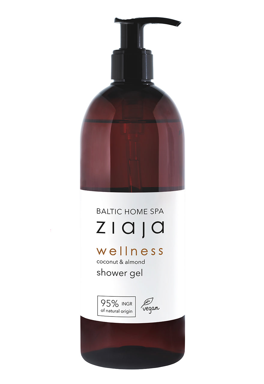 A dark brown bottle with a pump dispenser labeled 'Ziaja Baltic Home Spa wellness shower gel', with additional text indicating the product is vegan and contains coconut & almond extracts.