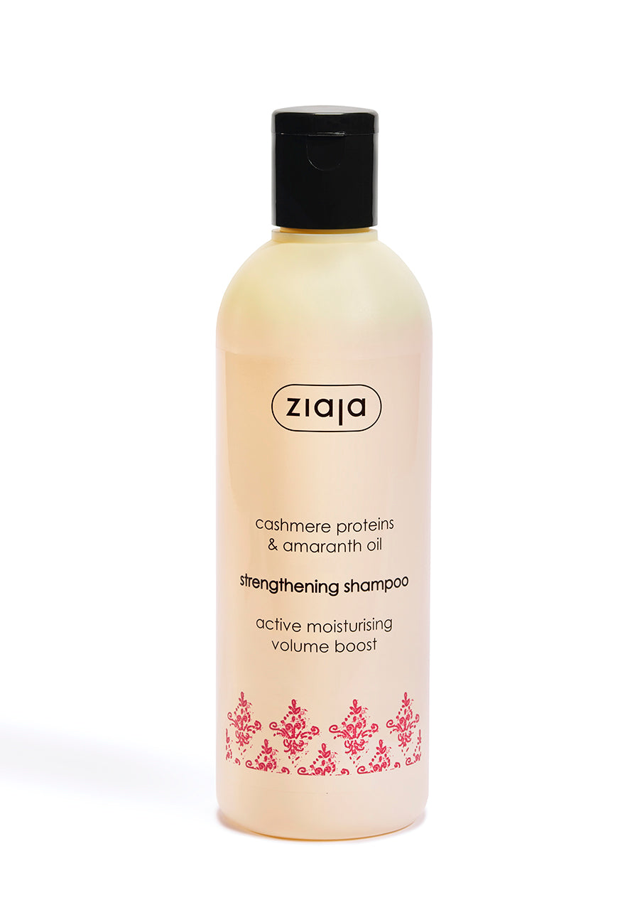 A bottle of Ziaja Cashmere Proteins Strengthening Shampoo with a capacity of 300ml. The label shows the brand name, product name, and an image of cashmere wool.