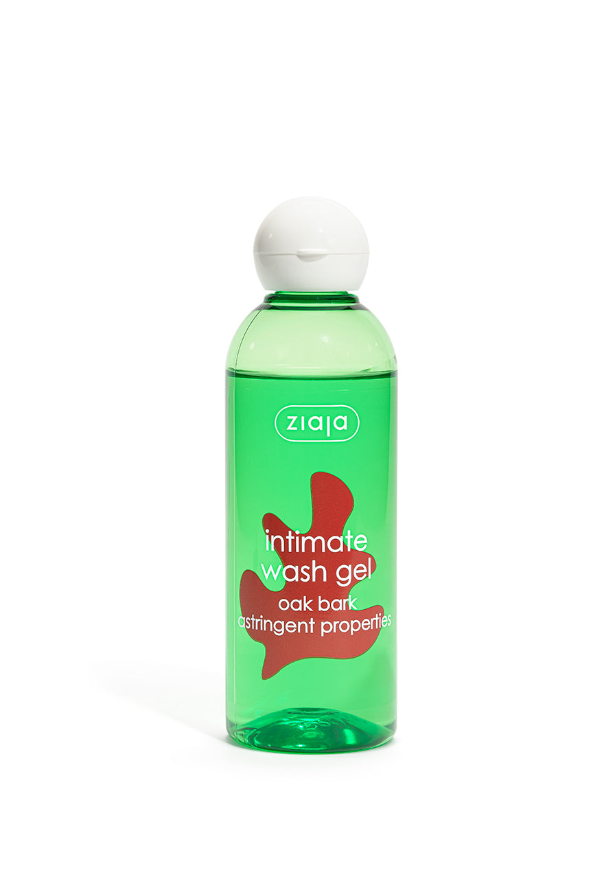 A clear bottle with green transparent liquid labeled Ziaja Intimate Wash oak bark  against a white background. 