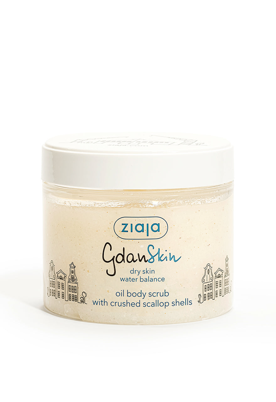 A jar of Ziaja Gdanskin Oil Body Scrub with a white label, featuring an illustration of a town and text indicating the product is an oil body scrub with crushed scallop shells.